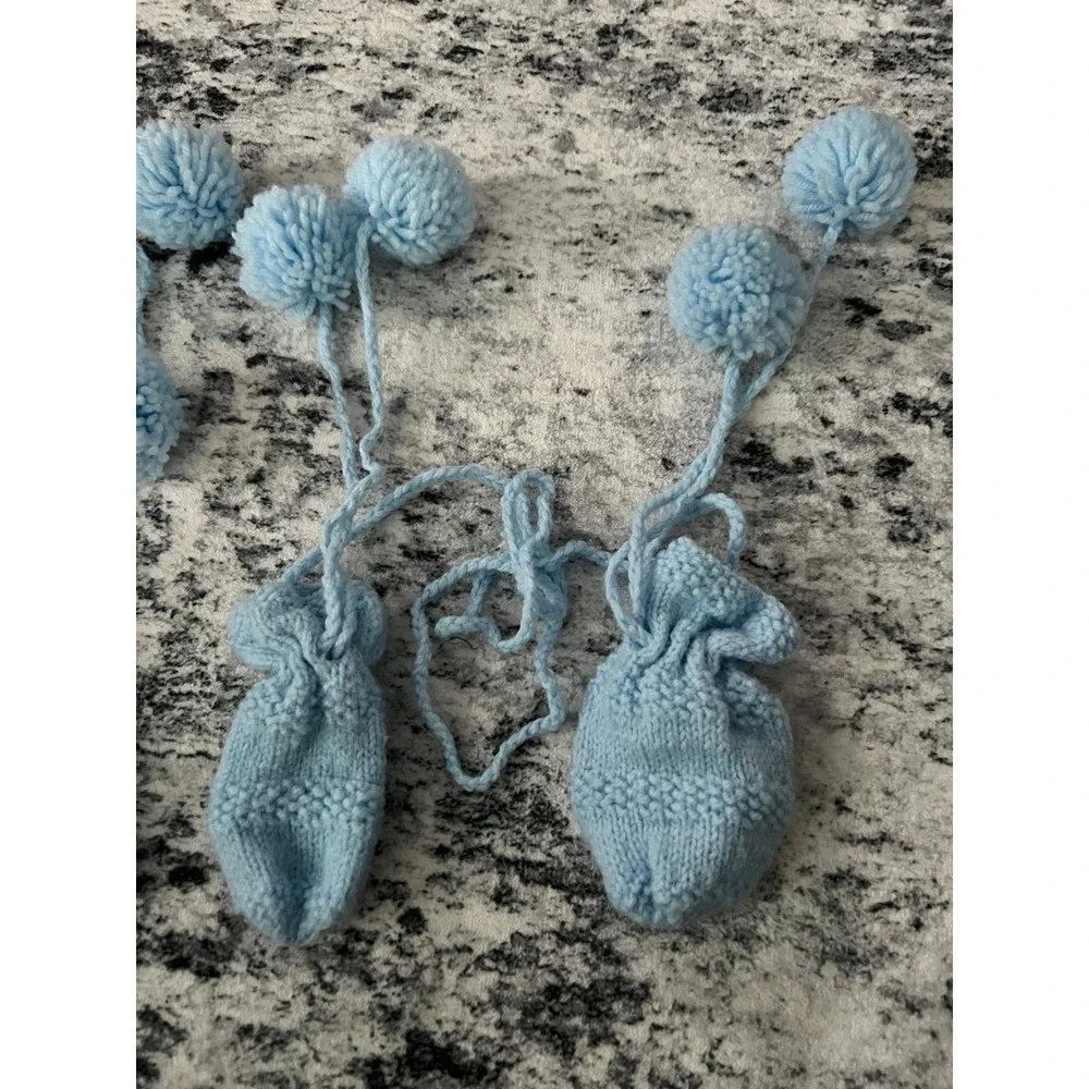 Knitted blue baby mittens and booties